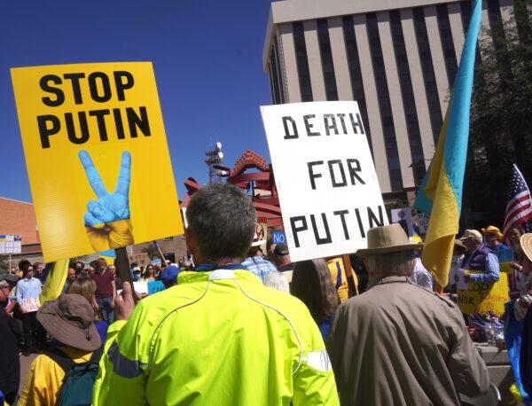 Protesters carry signs against the Russian invasion of Ukraine and Russian President Vladimir Putin during a rally in Tucson, Ariz., on March 6. (Allan Stein/The Epoch Times)