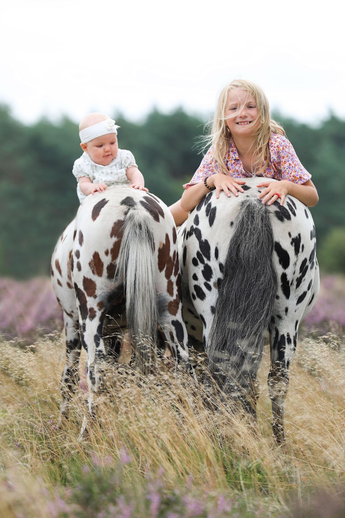 Greetje's children, Sunnery (L) and Jolie, on the back of the ponies. (Courtesy of Caters News)
