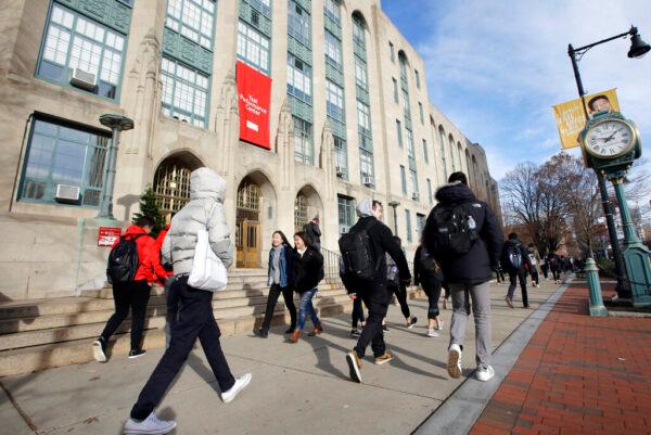 In this file photo, students and passers-by walk past an entrance to Boston University College of Arts and Sciences in Boston, on Nov. 29, 2018. (Steven Senne, File/AP Photo)