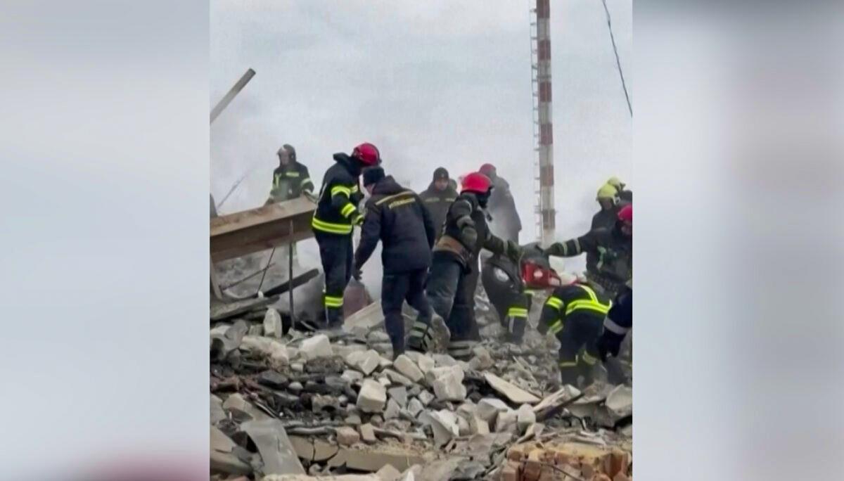 Emergency services personnel work following a missile strike on the Vinnytsia International Airport building in Vinnytsia, Ukraine, on March 6, 2022, in a still from a video. (Courtesy of Serhiy Borzov via Reuters/Screenshot via The Epoch Times)