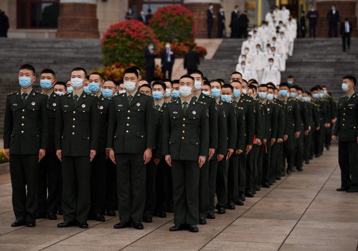 Military delegates stand in formation after commemorating the 110th anniversary of the Xinhai Revolution, which overthrew the Qing Dynasty and led to the founding of the Republic of China, at the Great Hall of the People in Beijing, on Oct. 9, 2021. (Noel Celis/AFP via Getty Images)