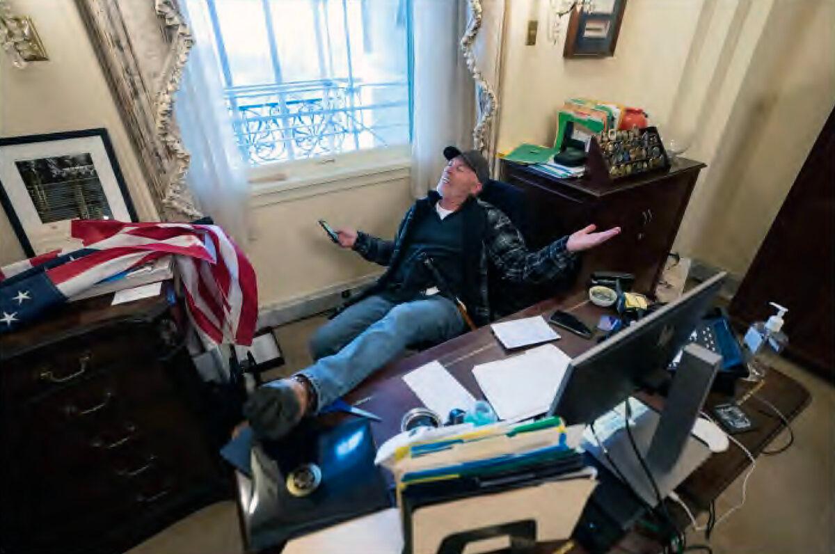Richard 'Bigo' Barnett poses for photos in the office of House Speaker Nancy Pelosi on Jan. 6, 2021. He was sentenced to 4.5 years in prison in May 2023. (U.S. Department of Justice/Screenshot via The Epoch Times)