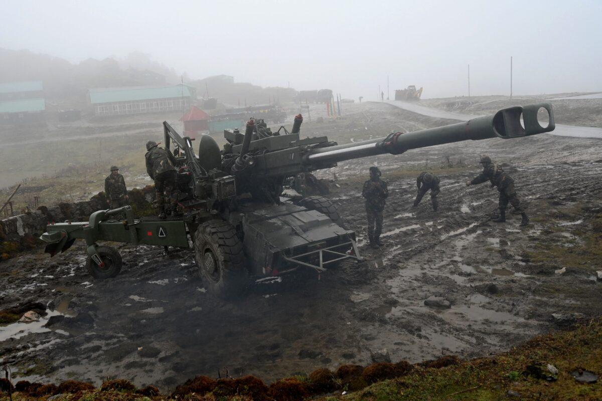 Indian Army soldiers demonstrate positioning of a Bofors gun at Penga Teng Tso ahead of Tawang, near the Line of Actual Control (LAC), neighboring China, in India's Arunachal Pradesh state on Oct. 20, 2021. (Money Sharma/AFP via Getty Images)