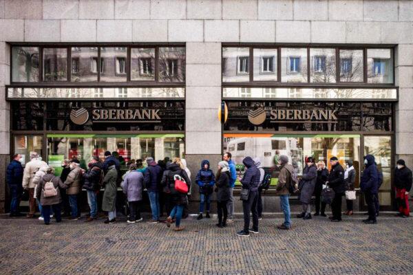 People queue outside a branch of Russian state-owned bank Sberbank to withdraw their savings and close their accounts in Prague on Feb. 25, 2022, before Sberbank closed all its branches in the Czech Republic later in the day. (Michal Cizek/AFP via Getty Images)