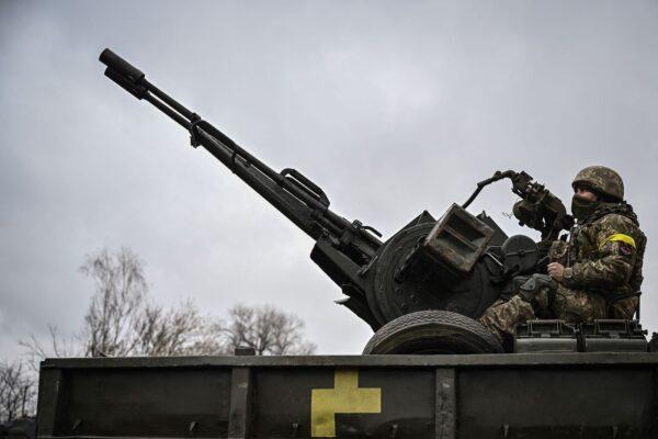A Ukrainian soldier keeps position sitting on a ZU-23-2 anti-aircraft gun at a frontline, northeast of Kyiv on March 3, 2022. (Aris Messinis/AFP via Getty Images)