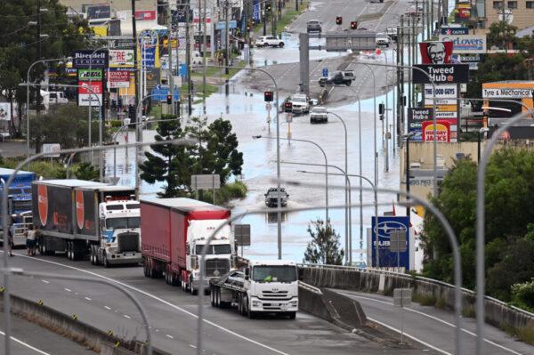 A flooded main street and stranded trucks in Tweed Heads, Australia, on March 1, 2022. (Dan Peled/Getty Images)
