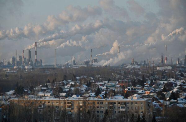 A general view shows a local oil refinery behind residential buildings in Omsk, Russia on Feb. 10, 2021. (Alexey Malgavko/Reuters)