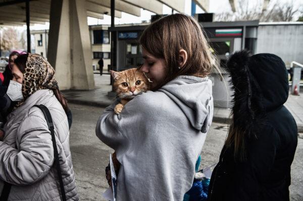 A Ukrainian refugee holds her pet cat as she and others arrive by bus at the Greek–Bulgarian border at Promachonas, Greece, on March 7, 2022. (Sakis Mitrolidis/AFP via Getty Images)