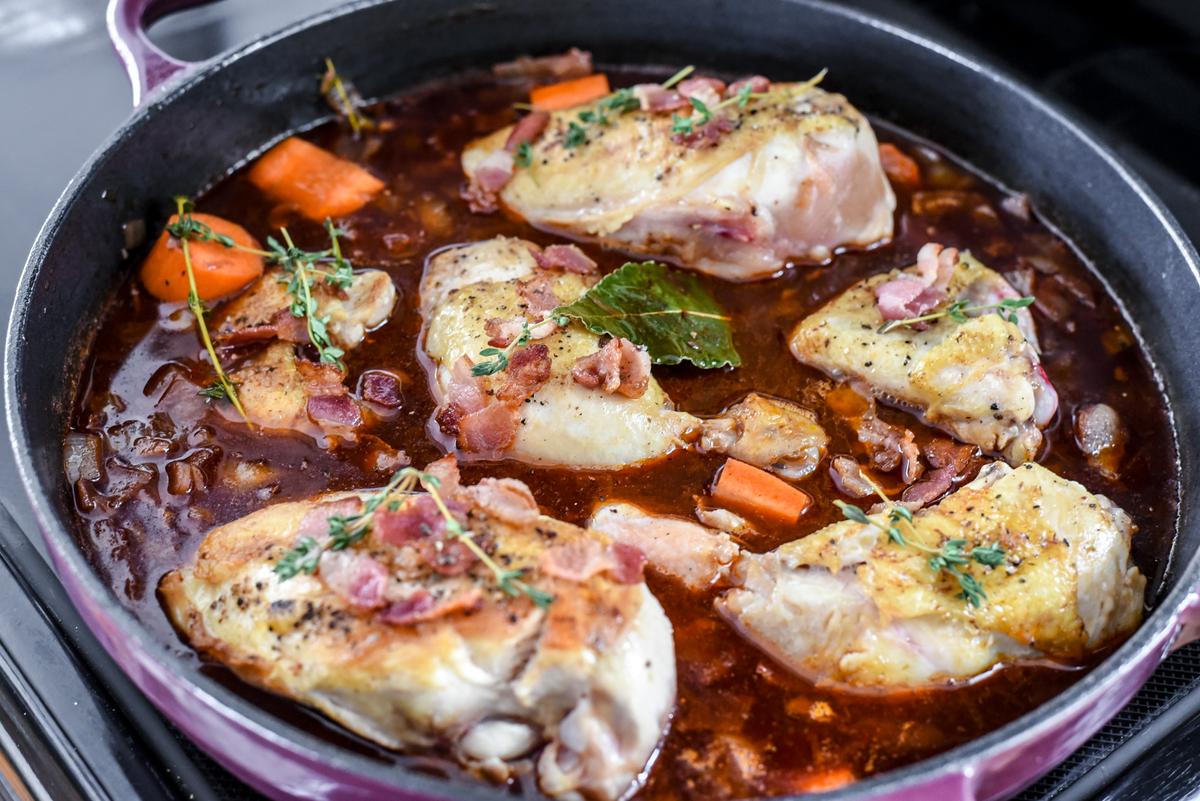 Add the chicken, carrots, bacon, and thyme, and transfer to the oven to cook through. (Audrey Le Goff)