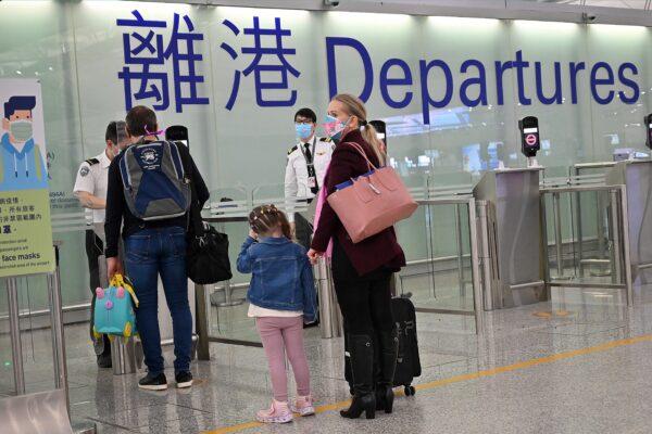 Families depart Hong Kong's Chek Lap Kok international airport on March 6, 2022 as travel restrictions hit hard on Hong Kong's white collar "expat" foreign workers. (Peter Parks/AFP via Getty Images)