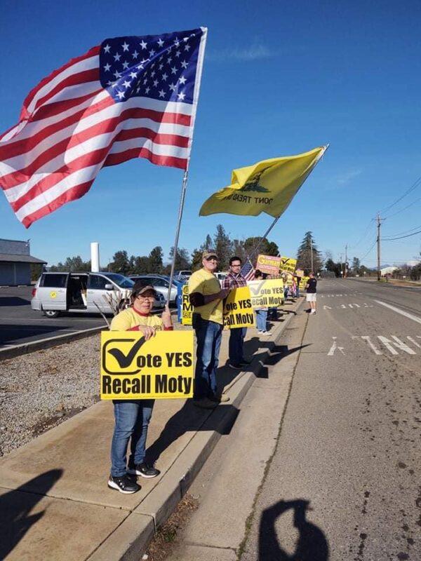 People hold signs in Redding, Calif., on Jan. 15, 2022, to call for a recall of former supervisor Leonard Moty. (Courtesy of Recall Shasta)