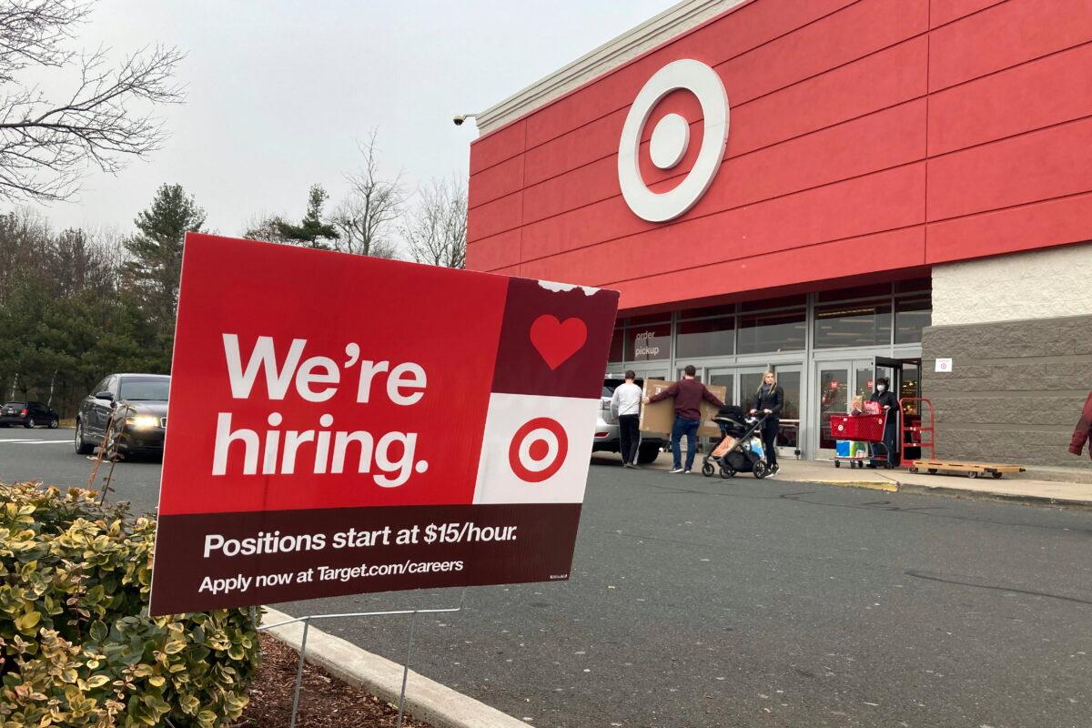 A hiring sign is in front of a Target store in Manchester, Conn., on Nov. 39, 2021. The Minneapolis-based discount retailer said on Feb. 28, 2022, that it would adopt minimum wages that range from $15 to $24 an hour, with the highest pay going to workers in the most competitive markets. It currently pays a universal starting wage of $15 an hour. (Ted Shaffrey/AP Photo)