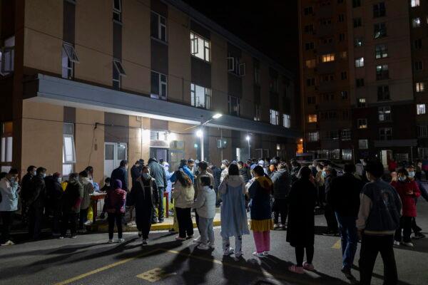 People line up for COVID-19 testing in a residential community in Shanghai, China, on March 10, 2022.  (AP Photo)