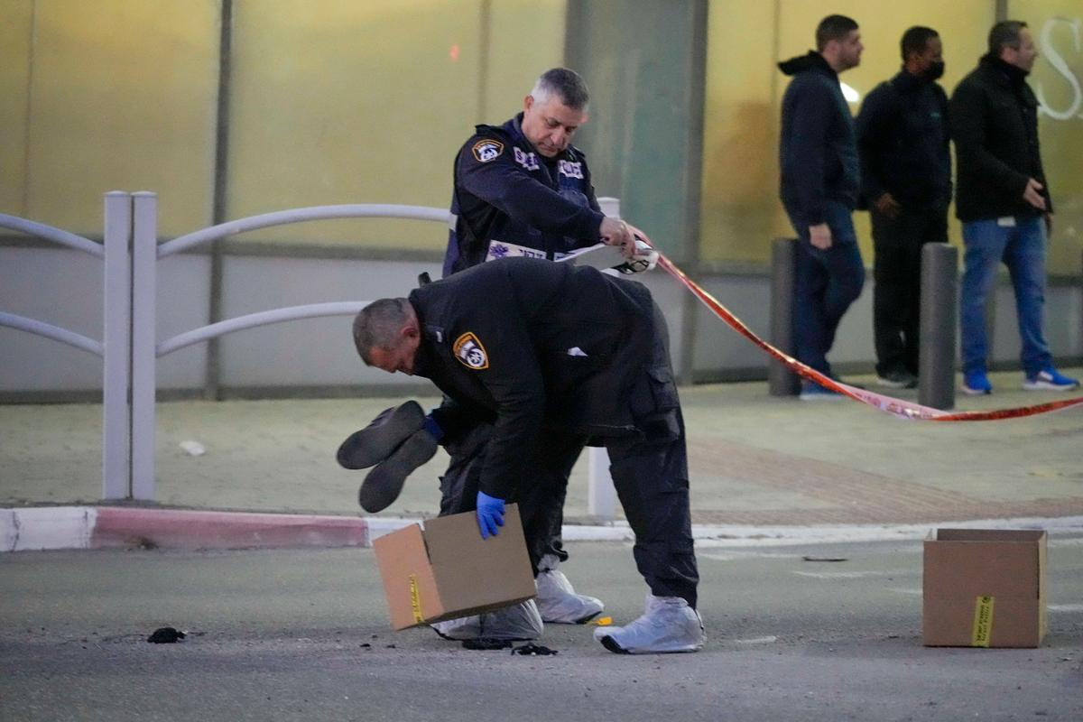 Policemen work at the scene of an attack in Beersheba, southern Israel, on March 22, 2022. (Tsafrir Abayov/AP Photo)