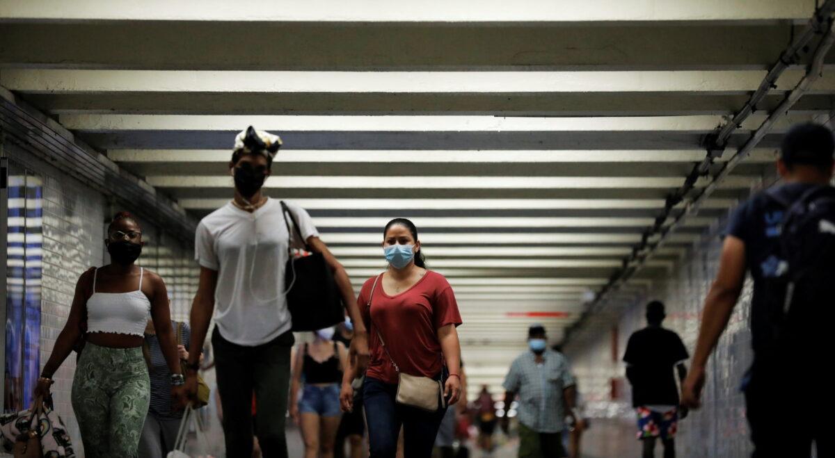 People wear masks as they pass through a pedestrian subway as infectious coronavirus Delta variant cases continued to rise in New York City, New York, on July 26, 2021. (Andrew Kelly/Reuters)