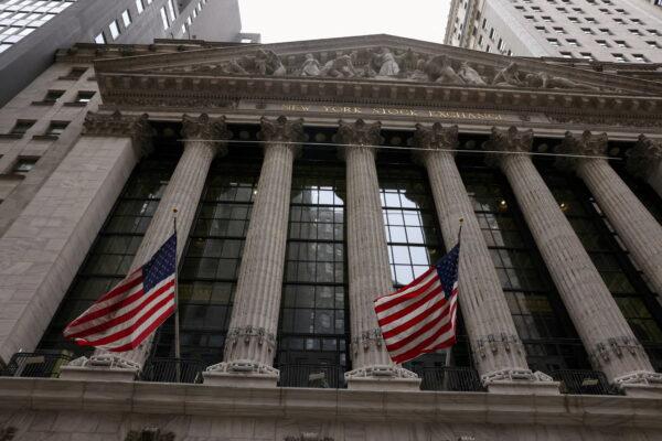 Flags are seen outside of the New York Stock Exchange (NYSE), where markets were roiled after Russia attacked Ukraine on Feb. 24, 2022. (Caitlin Ochs/Reuters)