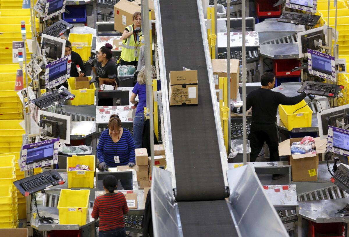 Workers prepare orders for customers at the Amazon Fulfillment Center in Tracy, Calif., on Nov. 29, 2015. (Fred Greaves/Reuters)