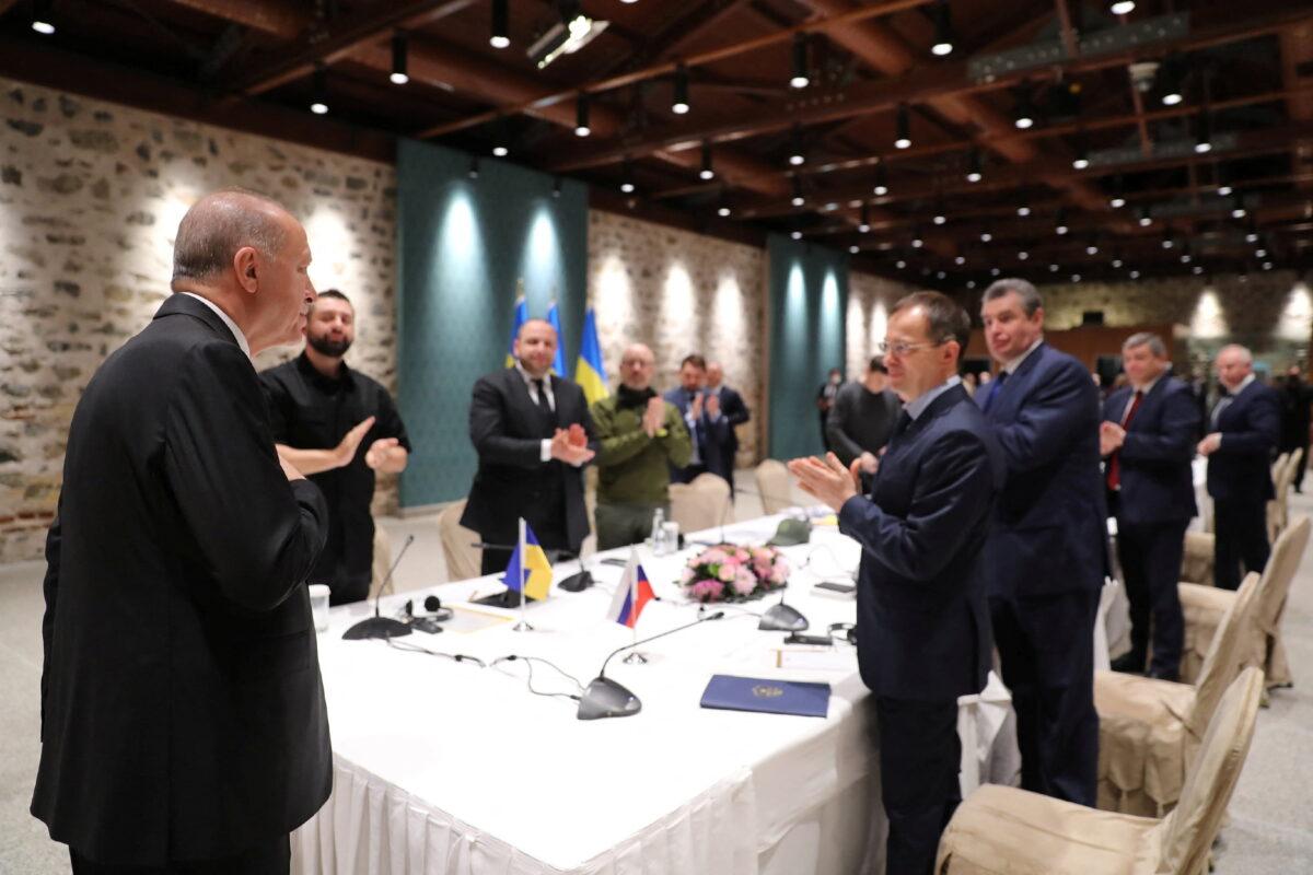 Turkish President Tayyip Erdogan greets Russian and Ukrainian negotiators ahead of their face-to-face talks in Istanbul, Turkey, on March 29, 2022. (Murat Cetinmuhurdar/Presidential Press Office/Handout via Reuters)
