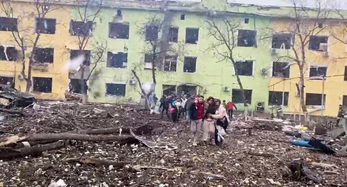A person is carried out after the destruction of Mariupol children's hospital as Russia's invasion of Ukraine continues, in Mariupol, Ukraine, on March 9, 2022 in this still image from a handout video obtained by Reuters. (Ukraine Military/Handout via Reuters)