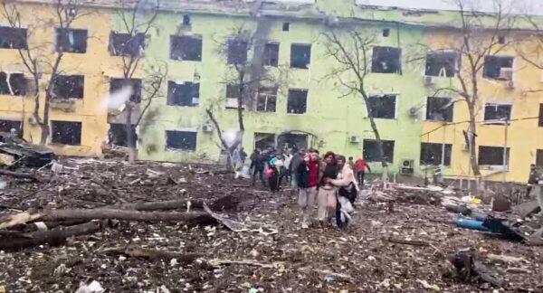 A person is carried out after the destruction of Mariupol children's hospital as Russia's invasion of Ukraine continues on March 9, 2022, in this still image from a handout video obtained by Reuters. (Ukraine Military/Handout via Reuters)
