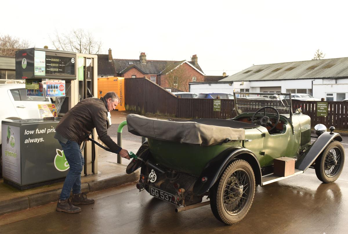 Mark filling up the gas tank of his 1931 Alvis. (Courtesy of Caters News)