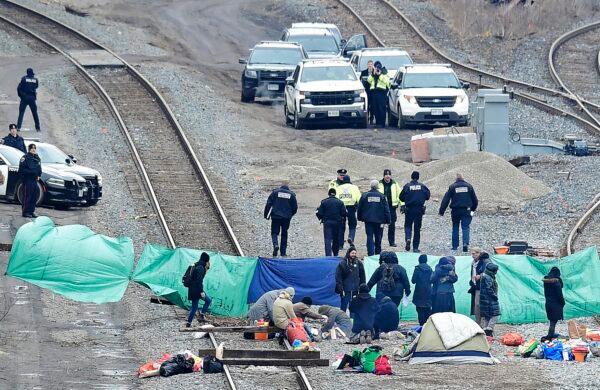 Police leave after speaking with protesters camped on GO Transit railroad tracks in Hamilton, Ont., as they demonstrate against the construction of a natural gas pipeline in northern B.C., on Feb. 25, 2020. (The Canadian Press/Frank Gunn)