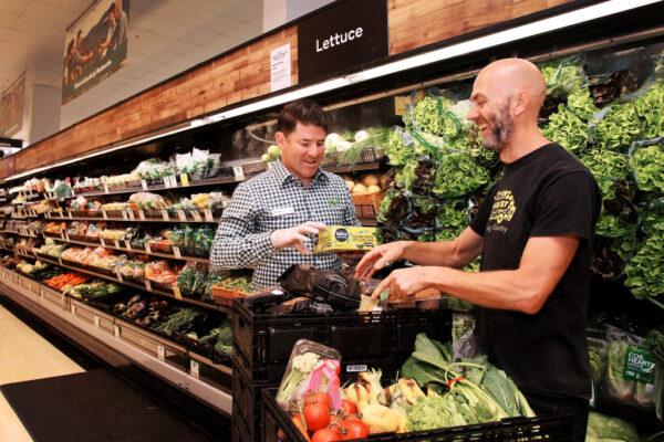 Simon Tracey, Woolworths National Community Manager, meets with Wayne Pinniger during a produce contribution to OzHarvest in Sydney, Australia, on April 22, 2020. (Lisa Maree Williams/Getty Images)