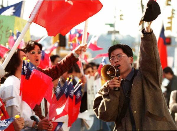 A demonstrator leads a group of Taiwanese Americans holding Taiwan flags in protest against Chinese aggression towards Taiwan during a rally in New York on March 13, 1996. (Robert Miller/AFP via Getty Images)