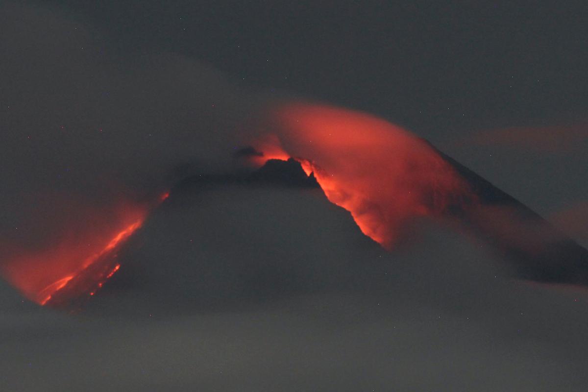 Lava flows down from the crater of Mount Merapi seen from Pakembinangun village in Sleman, Central Java, on March 10, 2022. (Ranto Kresek/AP Photo)
