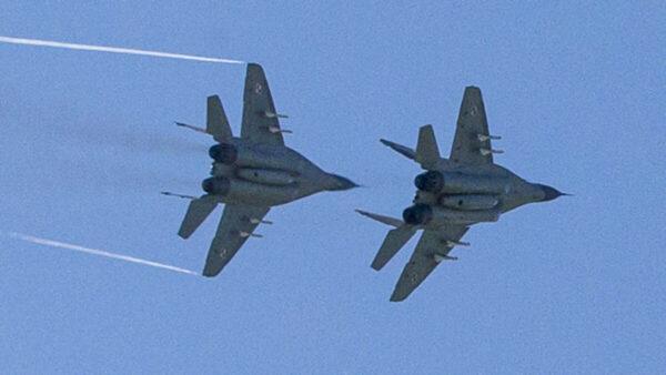 Two Polish MiG-29s fly over the air base in Malbork, Poland, on April 29, 2014. (Joel Saget/AFP via Getty Images)