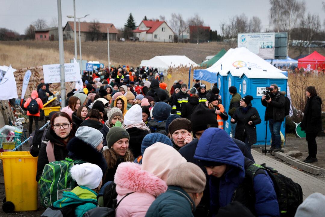 IN PHOTOS: Ukrainian Refugees Stream Into Poland