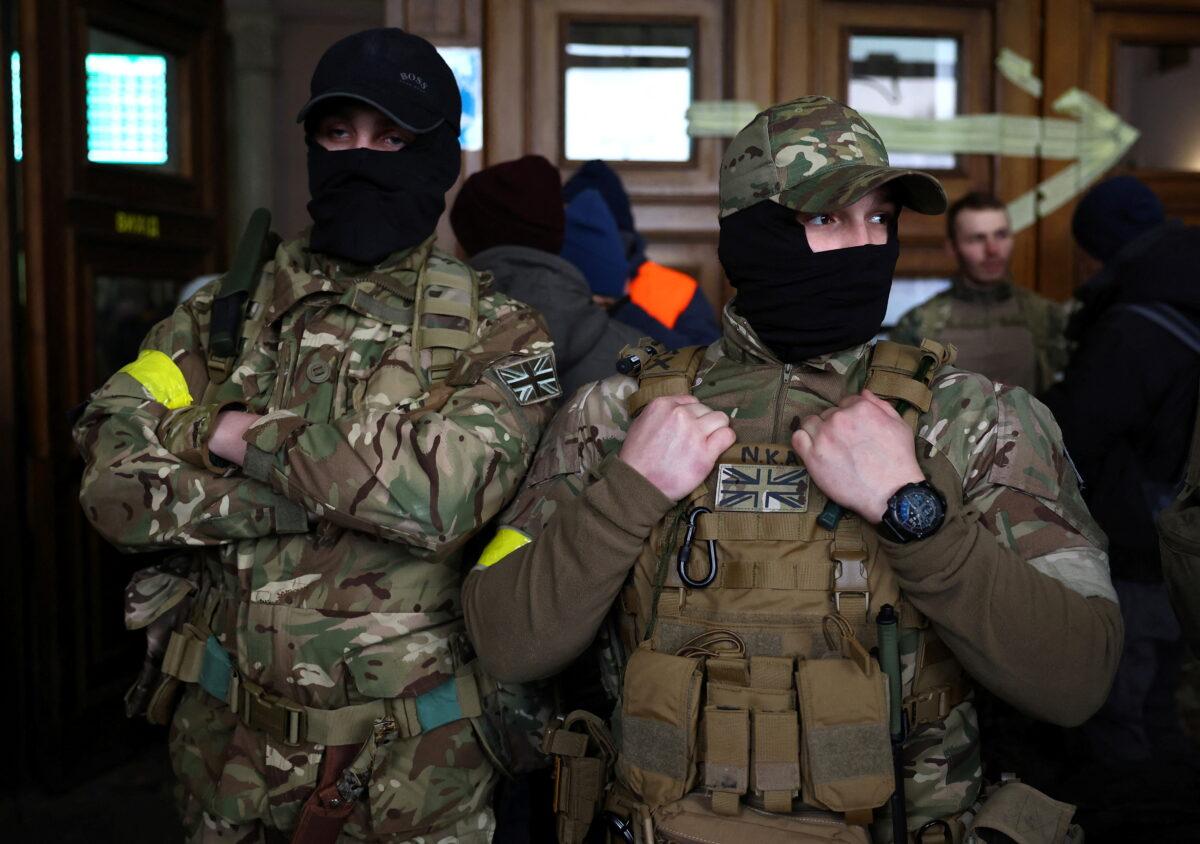 Two foreign fighters from the UK are ready to depart towards the front line in Lyiv, Ukraine, on March 5, 2022. (Kal Pfaffenbach/Reuters)