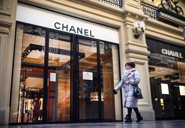 A woman walks past a closed Chanel shop in Moscow on March 10, 2022. (AFP via Getty Images)