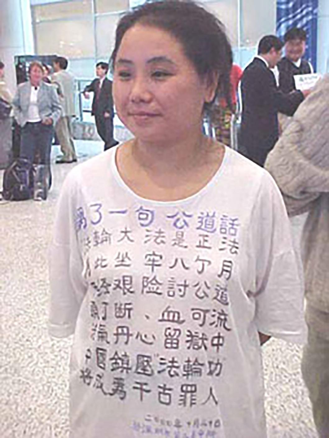 Zhang Cuiying in a T-shirt with a poem exposing the CCP's persecution of Falun Gong, at Shenzhen Airport waiting room, on Nov. 4, 2000. (Courtesy of Zhang Cuiying)