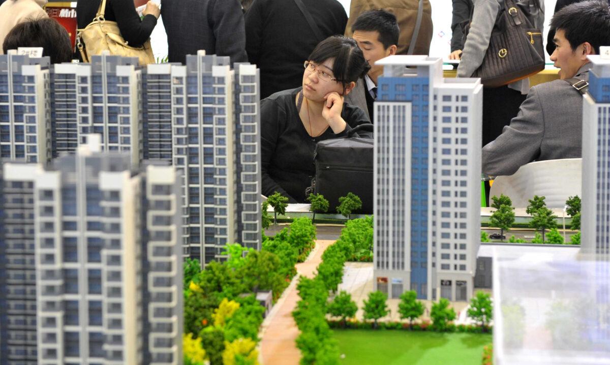 Chinese house shoppers gather at a property fair in Beijing on August 2, 2010. (STR/AFP via Getty Images)