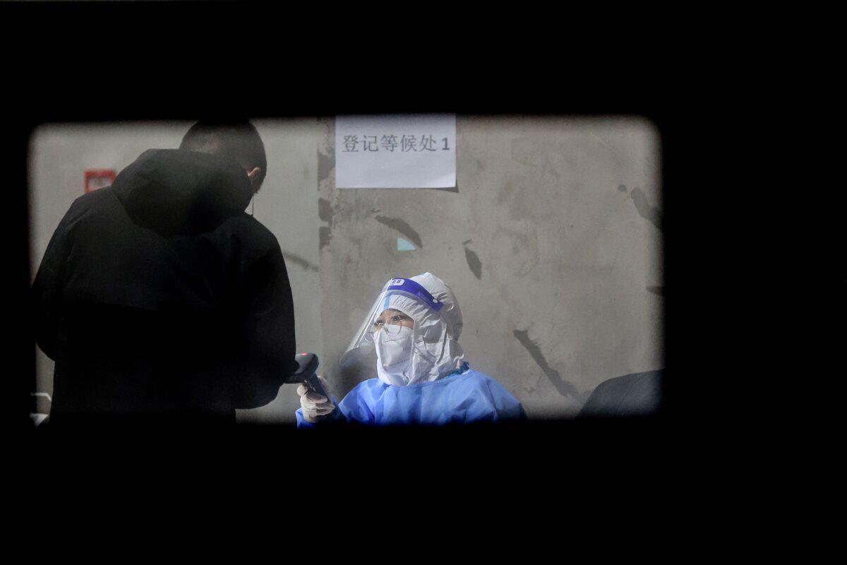 A resident undergoes a nucleic acid test for COVID-19 in Changchun city, Jilin Province, China, on March 11, 2022. (STR/AFP via Getty Images)