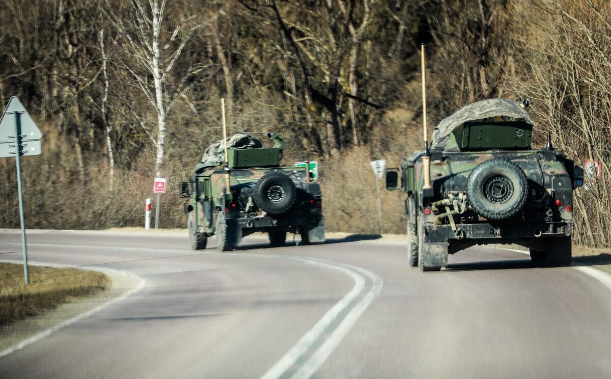 U.S. Army Humvees drive along a rural road within miles of the Ukraine border, in Poland on March 11, 2022. (Charlotte Cuthbertson/The Epoch Times)