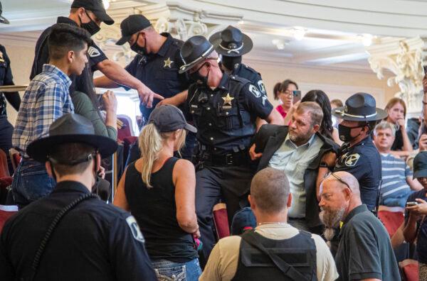 Ammon Bundy is dragged from the Idaho Senate Chambers gallery by Idaho State Troopers after returning to the Idaho Statehouse in Boise, Idaho, on Aug. 26, 2020. (Darin Oswald//Idaho Statesman via AP)