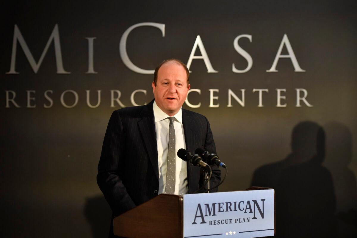 Colorado Gov. Jared Polis speaks about the success of the American Rescue Plan Act on the one-year anniversary of the law during his visit to the Mi Casa Resource Center in Denver, Colo., on March 11, 2022. (Jason Connolly/Pool/Getty Images)