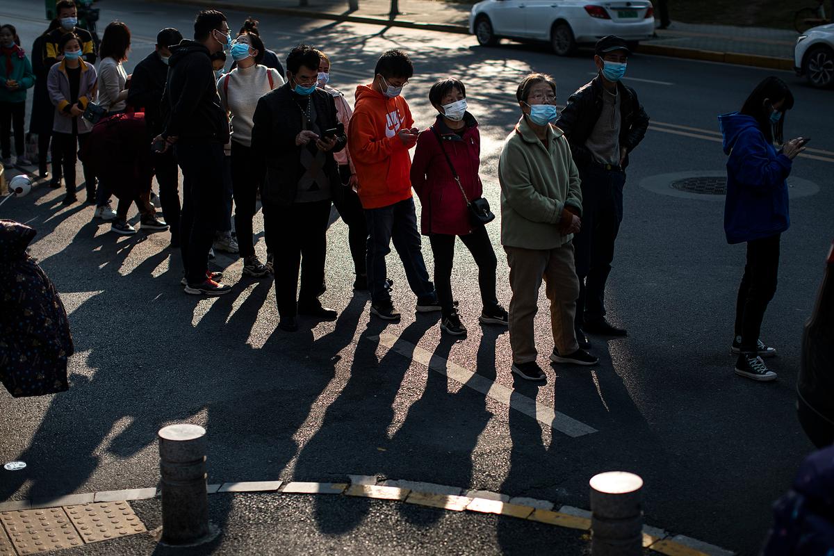 Residents wear masks while lining up to receive COVID-19 vaccines at a vaccination site in Wuhan, Hubei Province, China, on Nov. 18, 2021. (Getty Images)