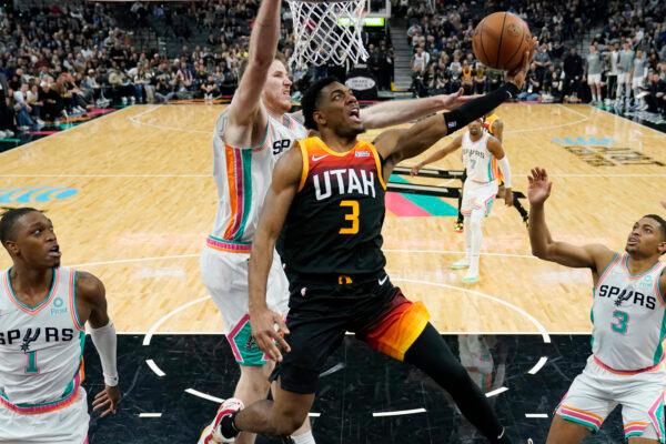 Utah Jazz guard Trent Forrest (3) drives to the basket against San Antonio Spurs center Jakob Poeltl (C) during the second half of an NBA basketball game in San Antonio, on March 11, 2022. (Eric Gay/AP Photo)