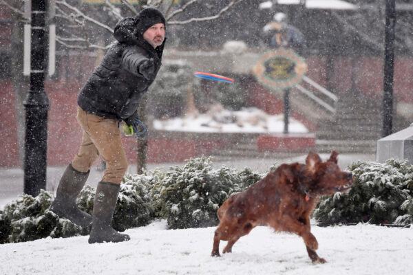  Jason Meyers of Burlington throws a frisbee for his dog Gilroy during a snowstorm in Burlington, Vt., on March 12, 2022. (Jessica Hill/AP Photo)