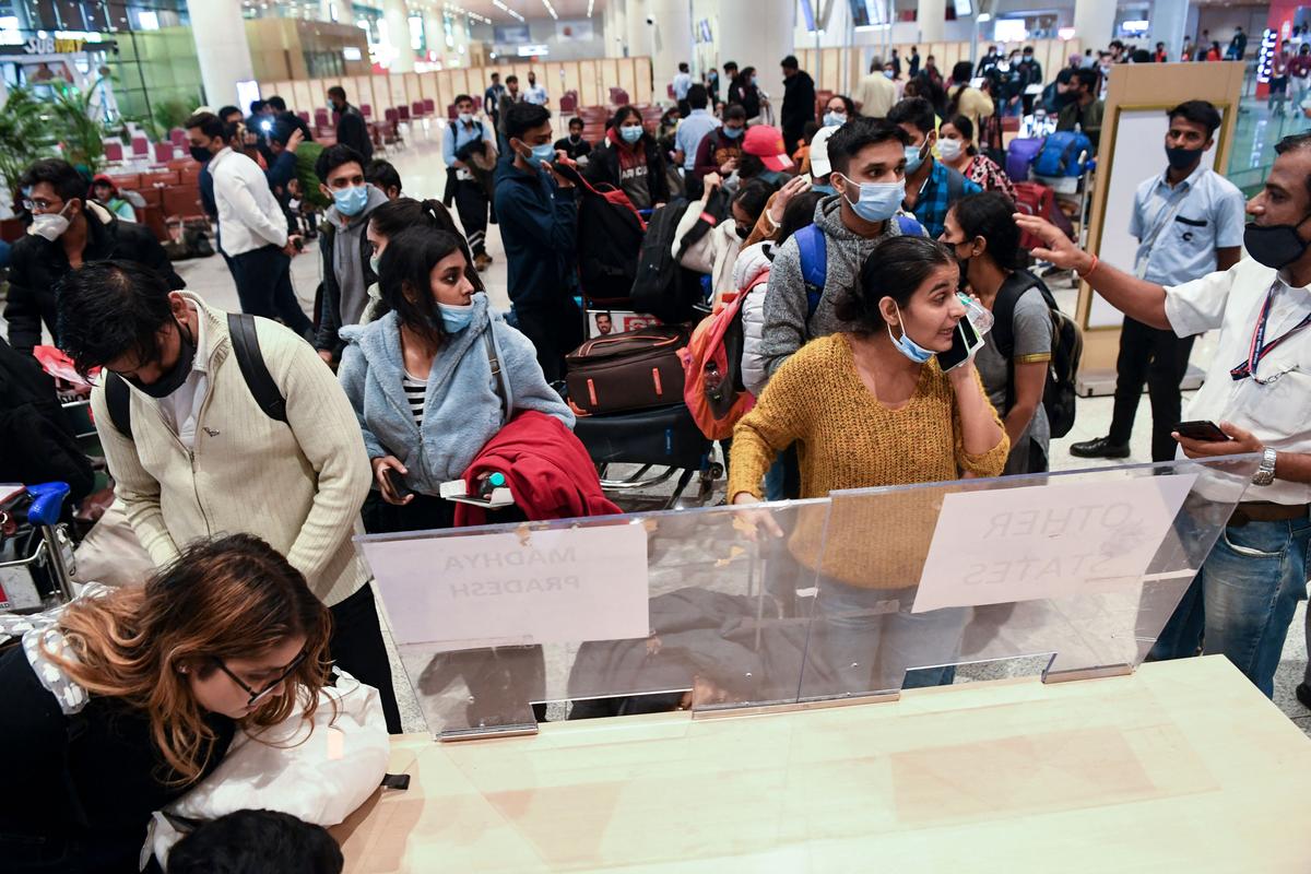 Students evacuated from Ukraine on a special flight from Bucharest wait for directions from officials at a helpdesk upon arriving at the Chhatrapati Shivaji Maharaj International Airport in Mumbai on March 1, 2022. (Indranil Mukherjee/AFP via Getty Images)