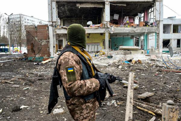 A member of the Ukrainian Territorial Defense Forces looks at destruction following a shelling in Ukraine's second-biggest city of Kharkiv on March 8, 2022. (Sergey Bobok/AFP via Getty Images)