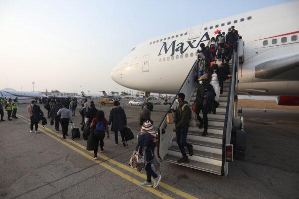Nigerian students, who just got evacuated from Ukraine amidst the ongoing war between Russia and Ukraine, disembark from a chartered plane after landing at the Nnamdi Azikwe Airport in Abuja, Nigeria, on March 4, 2022. (KOLA SULAIMON/AFP via Getty Images)
