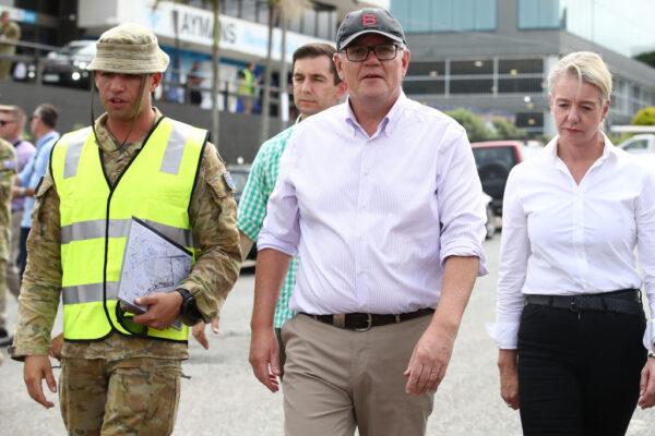 Prime Minister Scott Morrison (C) visits a flood-affected street in Milton with ADF personnel in Brisbane, Australia, on March 10, 2022. (Jono Searle/Getty Images)