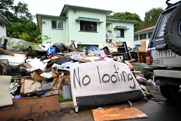 The words "No looting" are sprayed on discarded furniture outside a flood-affected house in Murwillumbah, Australia, on March 11, 2022. (Dan Peled/Getty Images)