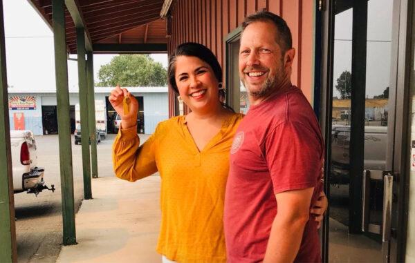 Melody and Chad Fowler hold keys to the new building for Roots Farm in Palo Cedro, Calif., on Aug. 12, 2021. (Courtesy of Roots Farm)