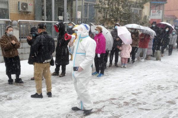 Residents line up for coronavirus screening during the COVID-19 lockdown in Changchun in northeastern China's Jilin province on March 12, 2022. (Chinatopix Via AP)
