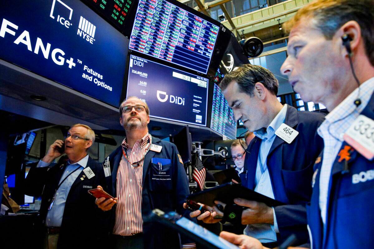 Traders work during the IPO of Chinese ride-hailing company Didi Global Inc. on the New York Stock Exchange (NYSE) floor in New York City on June 30, 2021. (Brendan McDermid/Reuters)